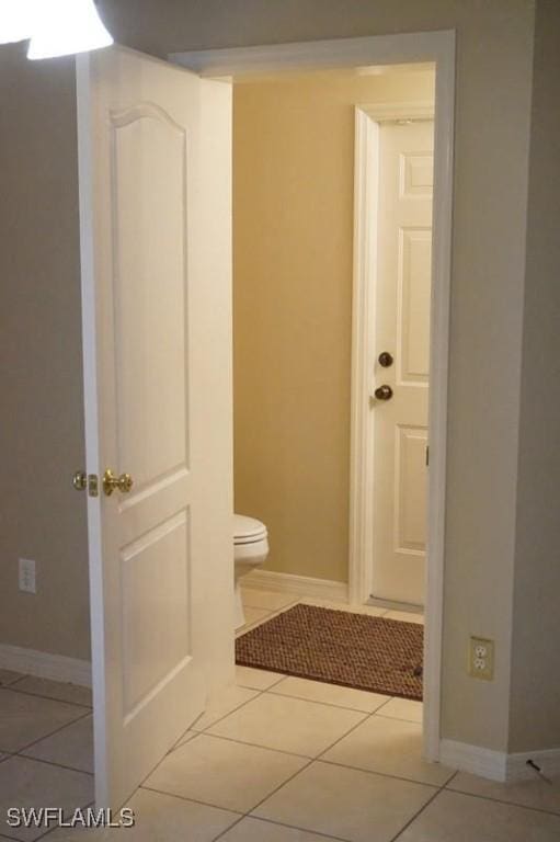 bathroom with toilet and tile patterned floors