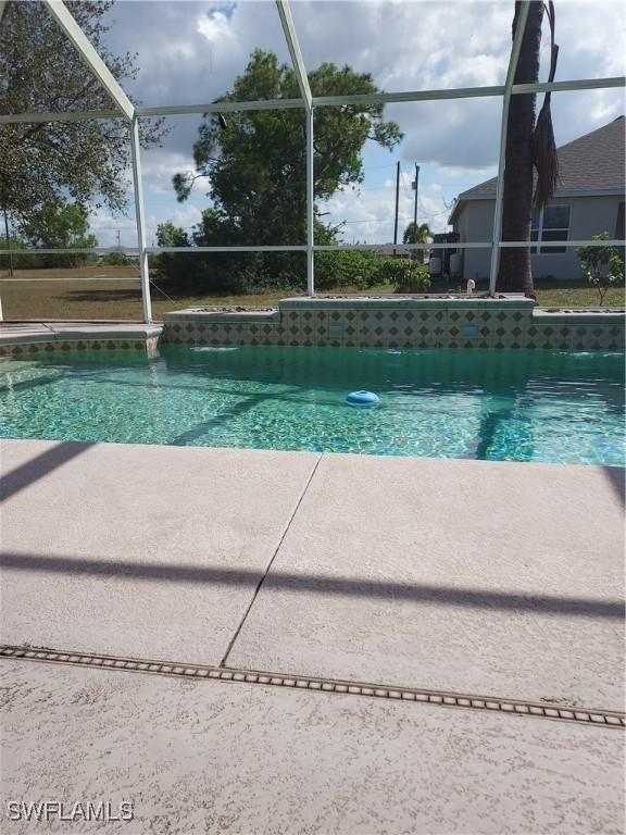 view of swimming pool with glass enclosure