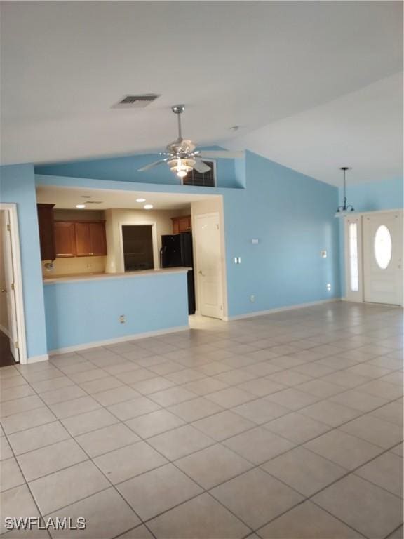 unfurnished living room with lofted ceiling, ceiling fan, and light tile patterned flooring