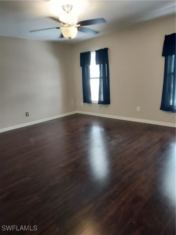 empty room featuring ceiling fan and dark hardwood / wood-style flooring