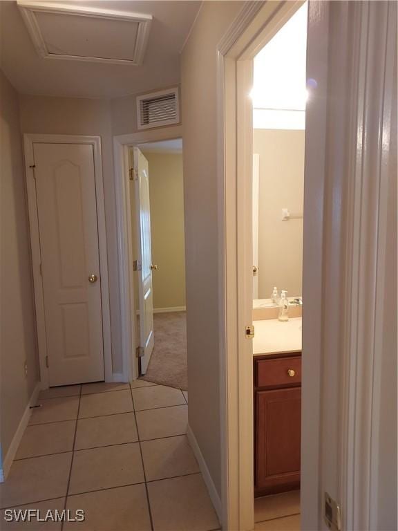 corridor featuring light tile patterned floors