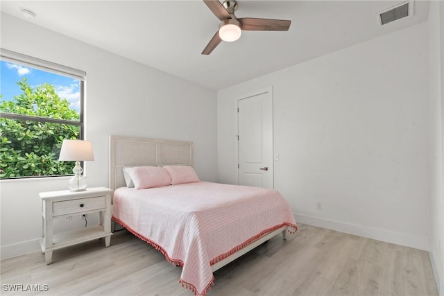 bedroom with light hardwood / wood-style flooring and ceiling fan