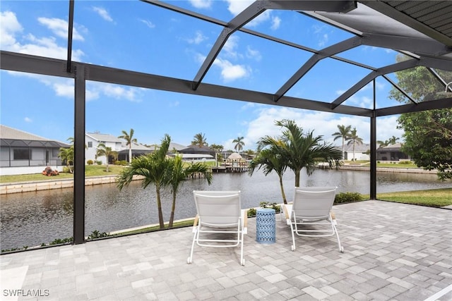 view of patio / terrace with a water view and a lanai