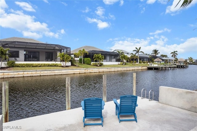 dock area featuring a water view and glass enclosure