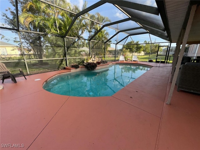 view of pool with a patio and glass enclosure