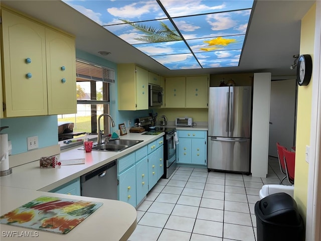 kitchen featuring light tile patterned flooring, stainless steel appliances, and sink