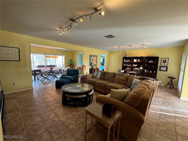 living room featuring tile patterned flooring and track lighting