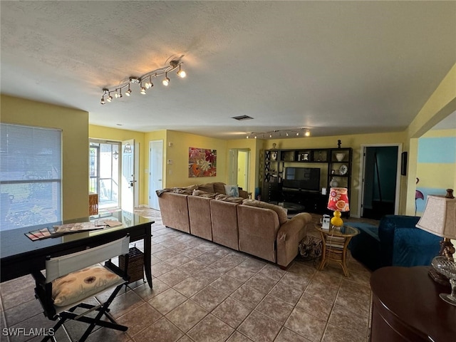 living room with tile patterned flooring and a textured ceiling