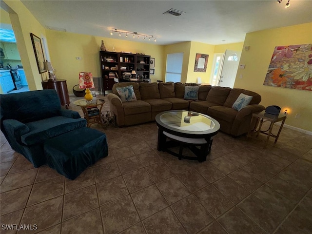 tiled living room featuring track lighting