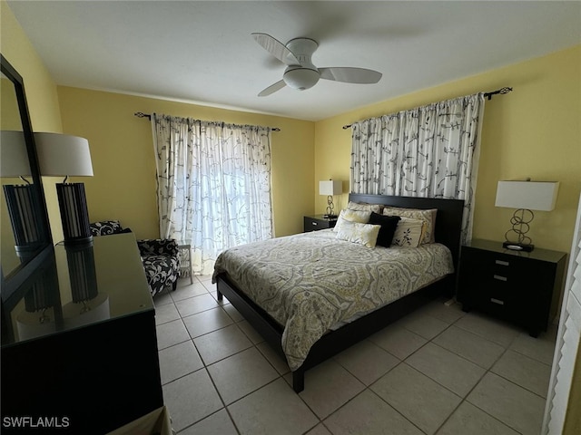 tiled bedroom featuring ceiling fan