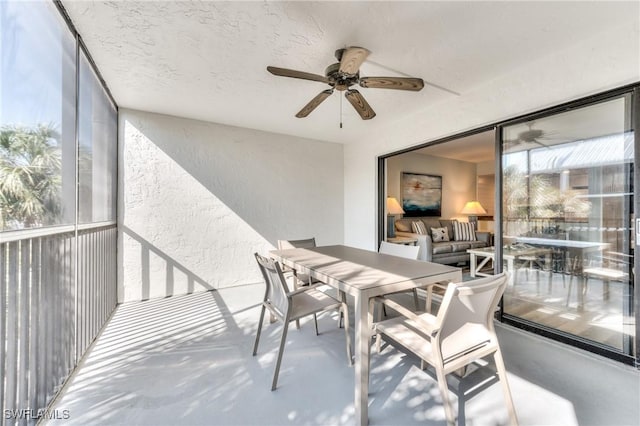 sunroom / solarium featuring ceiling fan