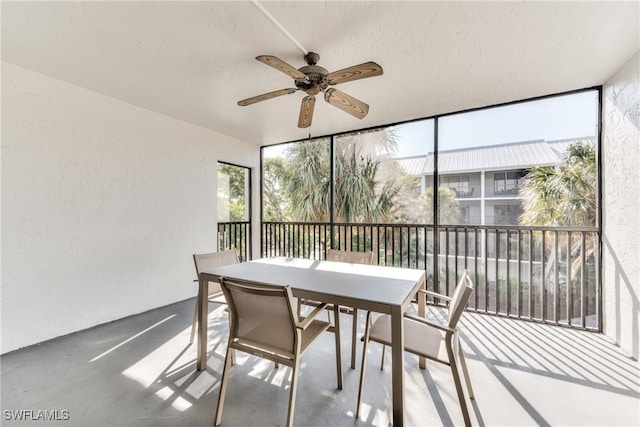 sunroom / solarium featuring ceiling fan