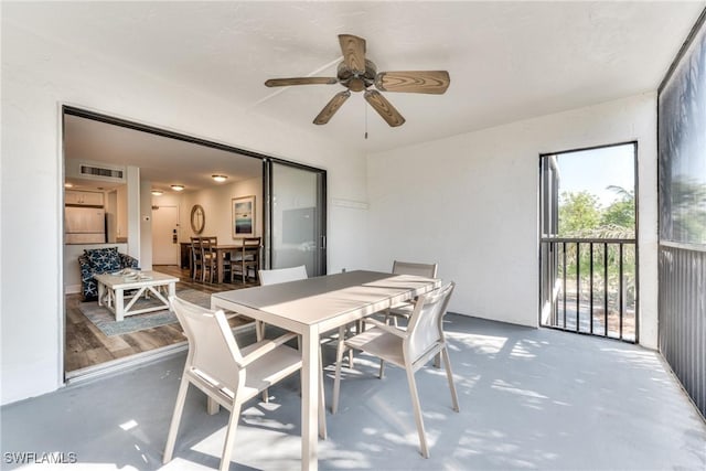 sunroom / solarium featuring ceiling fan