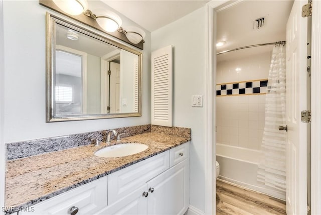 full bathroom with toilet, vanity, shower / bath combo with shower curtain, and hardwood / wood-style floors