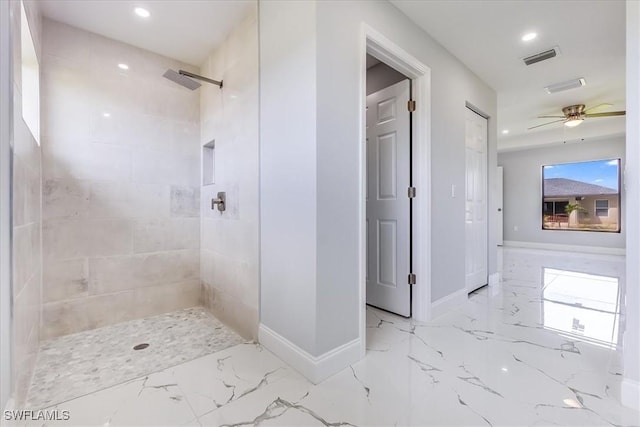 bathroom featuring ceiling fan, a tile shower, and plenty of natural light