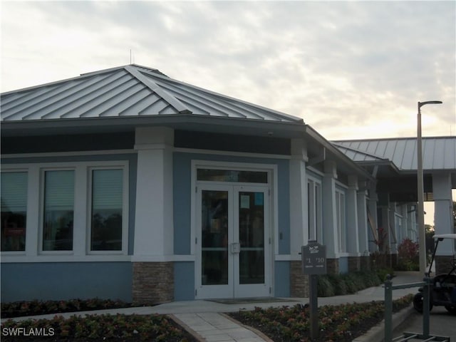 view of side of property featuring french doors