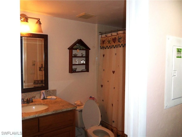 bathroom with toilet and vanity