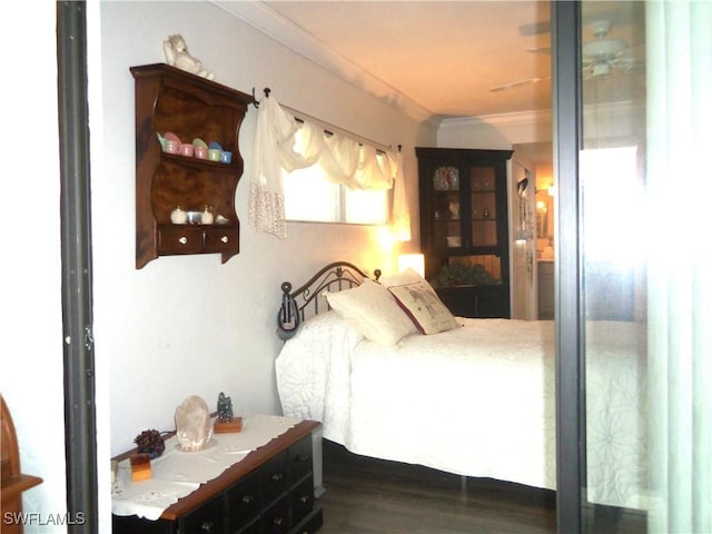 bedroom with dark wood-type flooring and ornamental molding