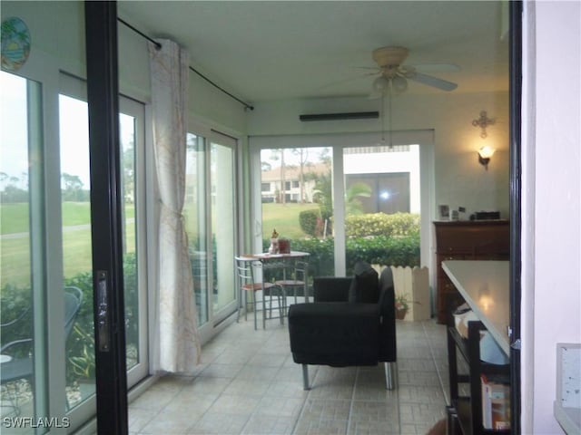 sunroom / solarium featuring ceiling fan