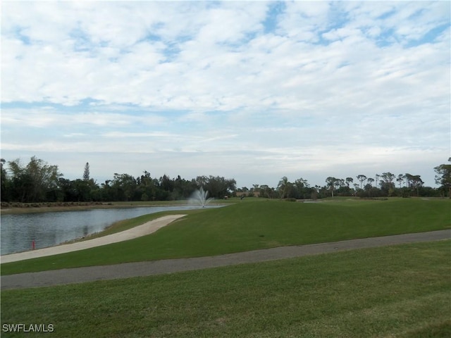 view of community with a water view and a lawn