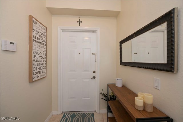 doorway to outside featuring tile patterned floors