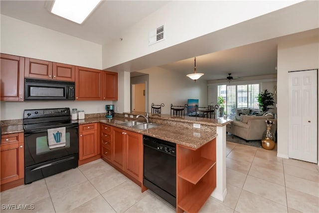 kitchen with decorative light fixtures, ceiling fan, black appliances, kitchen peninsula, and sink