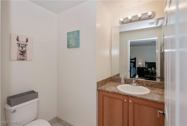 bathroom with toilet and vanity