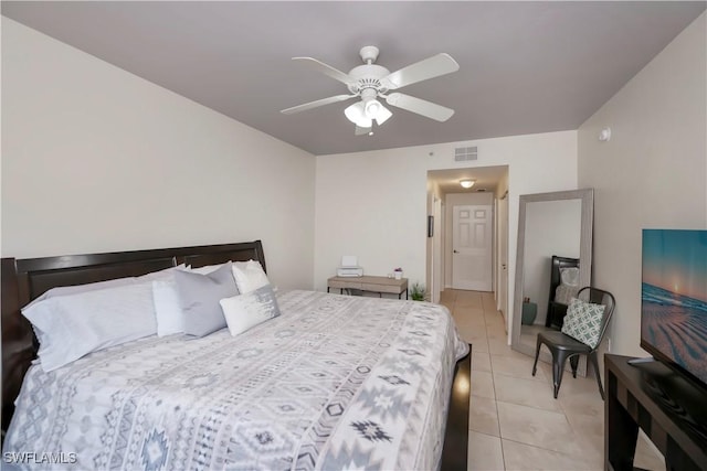 bedroom with ceiling fan and light tile patterned floors