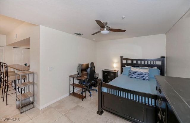 tiled bedroom featuring ceiling fan