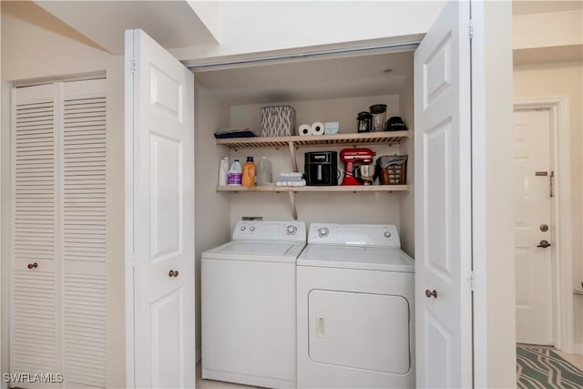 washroom featuring washer and clothes dryer