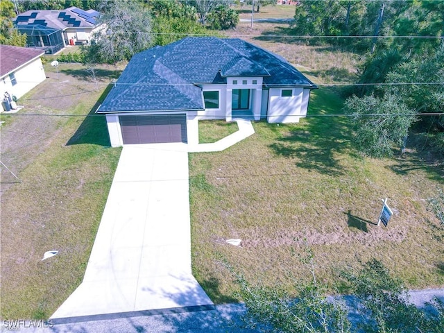 view of front of home with a front yard and a garage