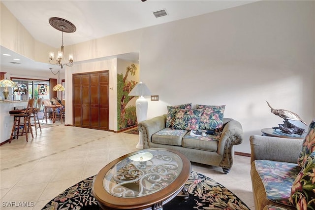 living room with light tile patterned floors and a chandelier