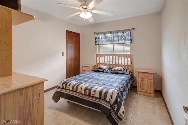 tiled bedroom featuring ceiling fan