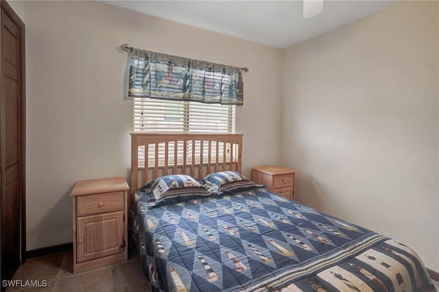 tiled bedroom featuring ceiling fan