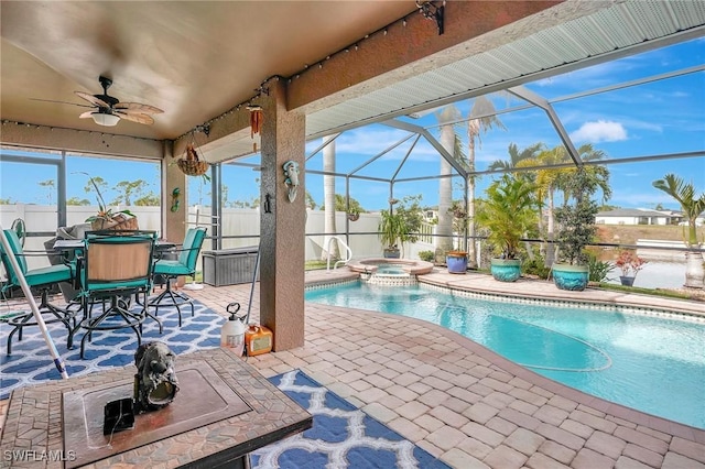 view of swimming pool with a patio, ceiling fan, an in ground hot tub, and glass enclosure