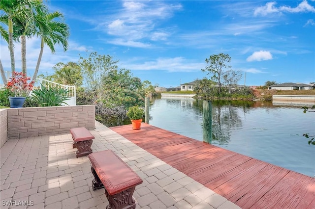 dock area featuring a water view and a patio area