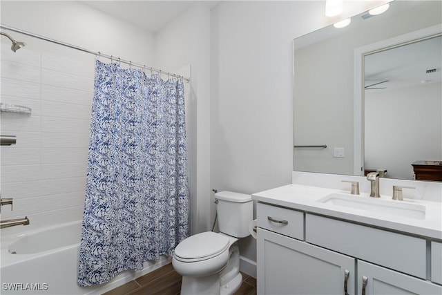 full bathroom with shower / bathtub combination with curtain, vanity, and toilet