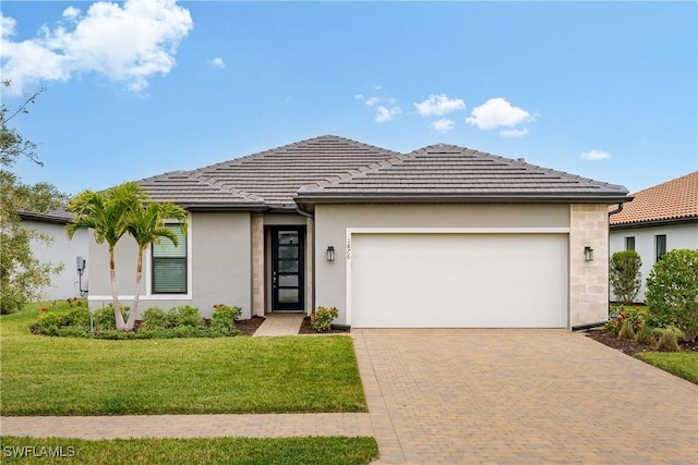 view of front of property with a front lawn and a garage