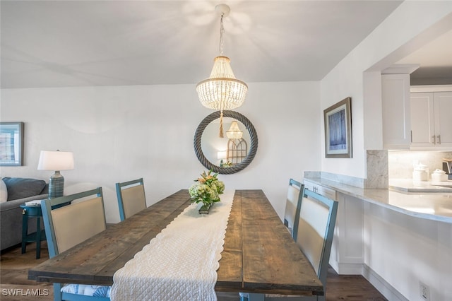 dining room featuring dark wood-type flooring and a notable chandelier