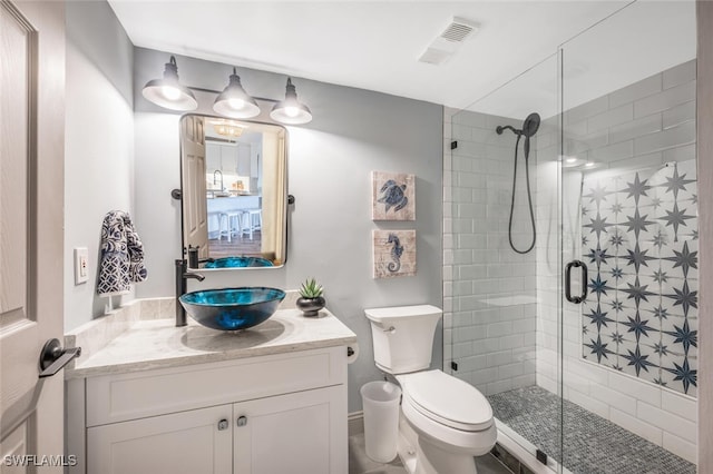 bathroom featuring walk in shower, vanity, and toilet