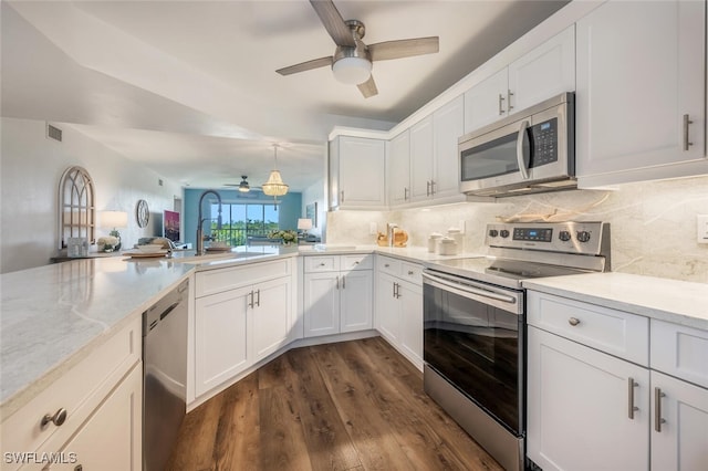 kitchen featuring stainless steel appliances, dark hardwood / wood-style floors, sink, and white cabinets