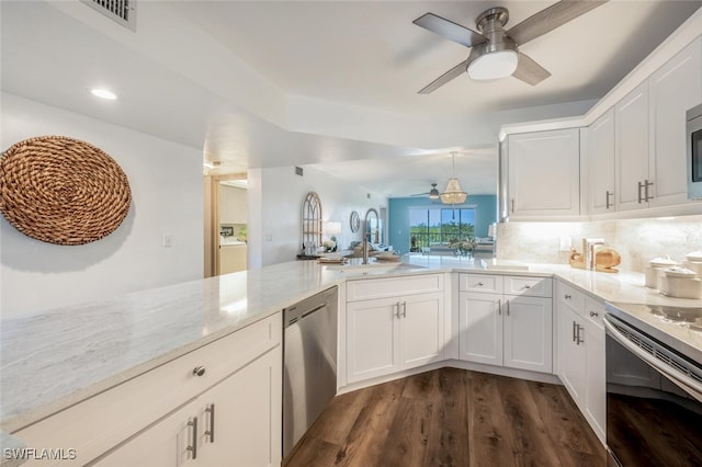 kitchen with sink, stainless steel appliances, white cabinets, dark hardwood / wood-style flooring, and washer / clothes dryer