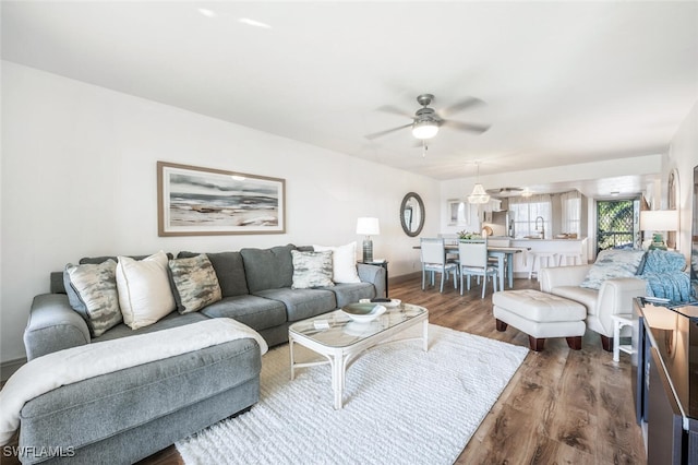 living room with sink, dark hardwood / wood-style floors, and ceiling fan