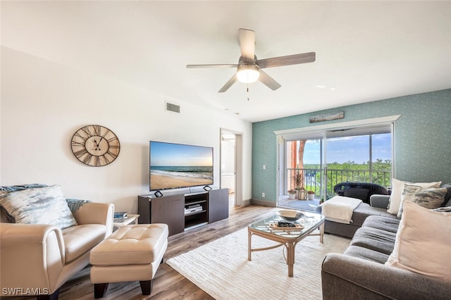 living room with light wood-type flooring and ceiling fan