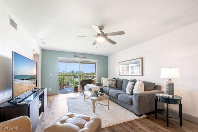 living room with ceiling fan and light hardwood / wood-style floors