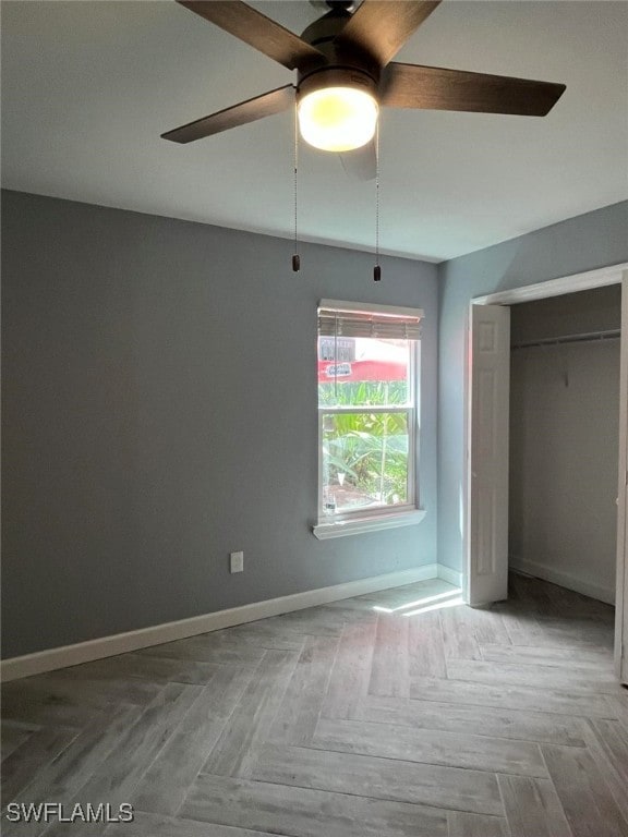 unfurnished bedroom with ceiling fan, a closet, and light parquet floors