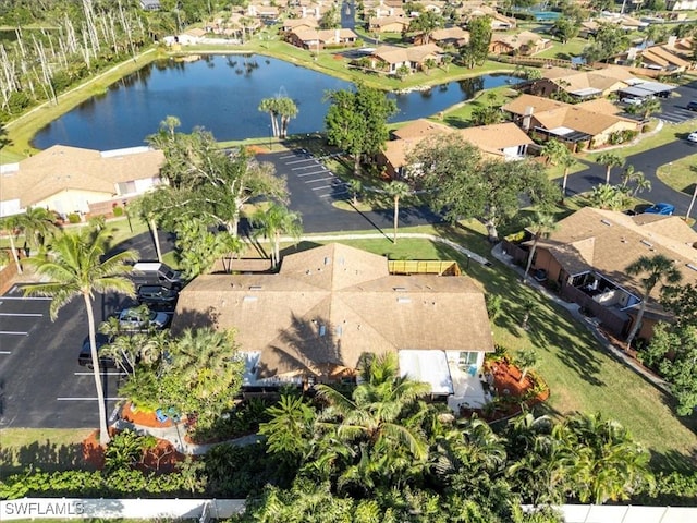 drone / aerial view featuring a residential view and a water view