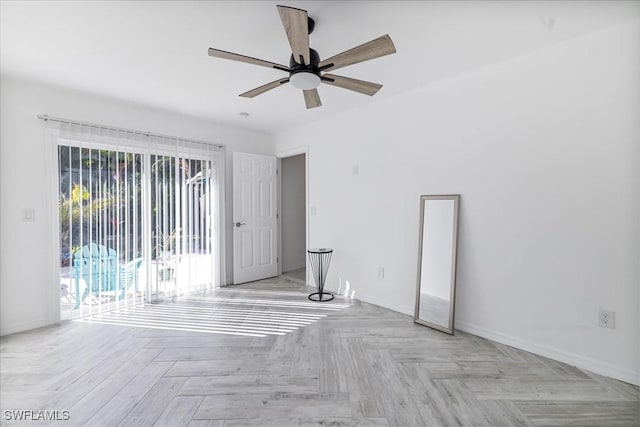 empty room featuring a ceiling fan and baseboards