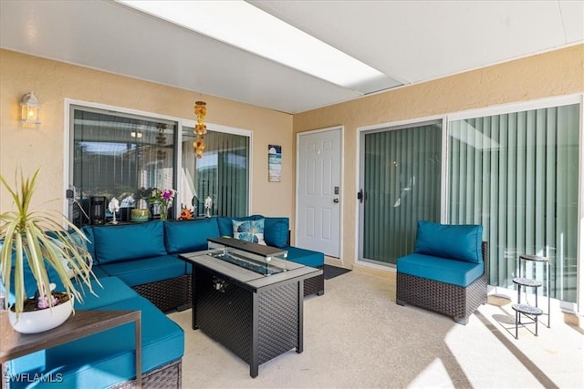 view of patio featuring an outdoor living space with a fire pit