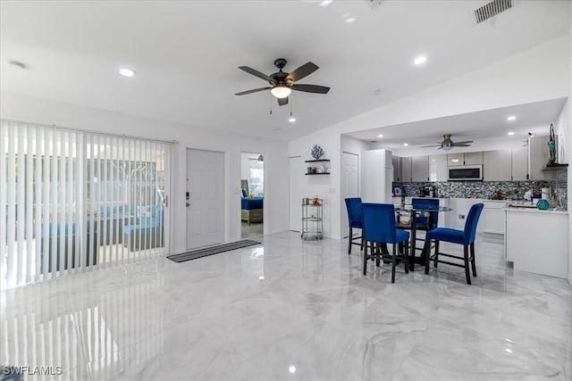 dining area featuring visible vents, vaulted ceiling, a ceiling fan, and recessed lighting